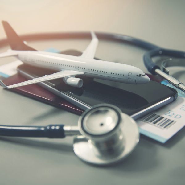 Model Plane on a Passport and surrounding be a stethoscope